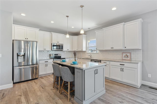 kitchen with white cabinetry, appliances with stainless steel finishes, and a sink