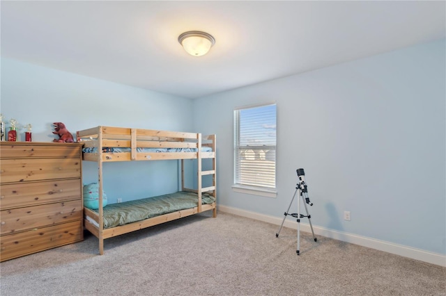 bedroom featuring carpet floors and baseboards