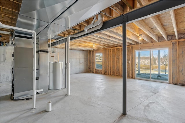 basement featuring heating unit, gas water heater, and electric panel