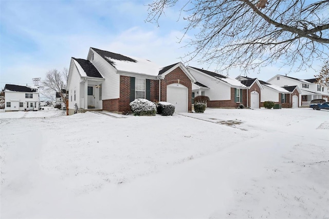 view of snowy exterior with a garage