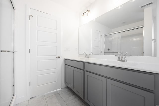 full bath with marble finish floor, double vanity, visible vents, a sink, and a shower stall