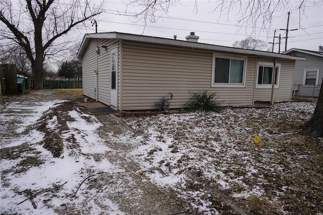 view of snowy exterior featuring fence