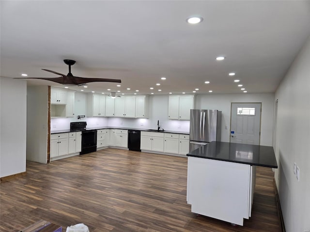 kitchen with white cabinetry, sink, dark hardwood / wood-style flooring, ceiling fan, and black appliances