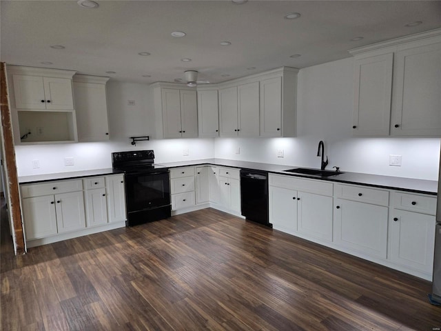 kitchen featuring white cabinetry, sink, dark hardwood / wood-style floors, and black appliances