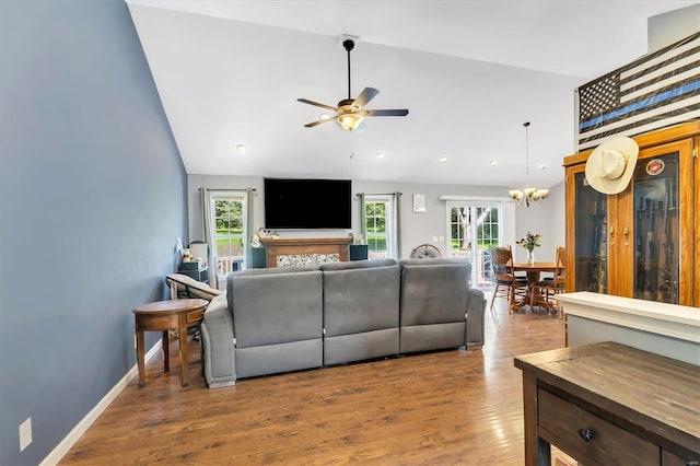 living room featuring lofted ceiling, a healthy amount of sunlight, and hardwood / wood-style floors