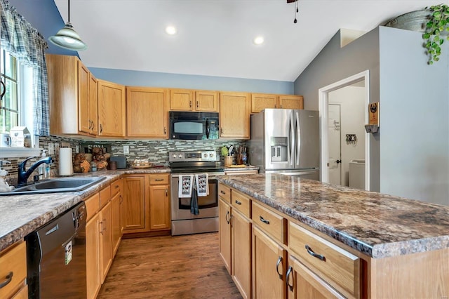 kitchen featuring dark wood-type flooring, sink, decorative light fixtures, a center island, and black appliances