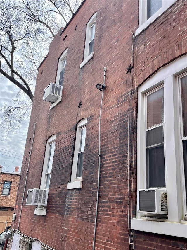 view of property exterior with cooling unit and a wall unit AC