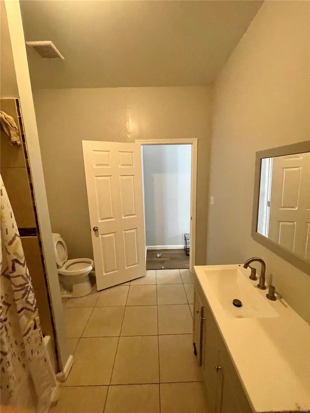 bathroom with tile patterned flooring, vanity, a shower with shower curtain, and toilet