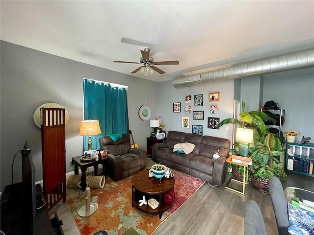 living room featuring hardwood / wood-style floors and ceiling fan