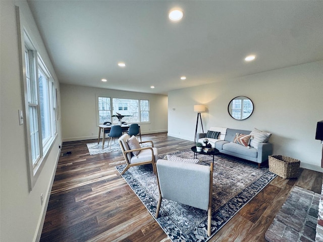 living room with baseboards, dark wood-type flooring, and recessed lighting