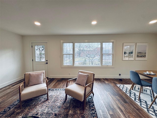 sitting room featuring dark wood-type flooring, recessed lighting, and baseboards