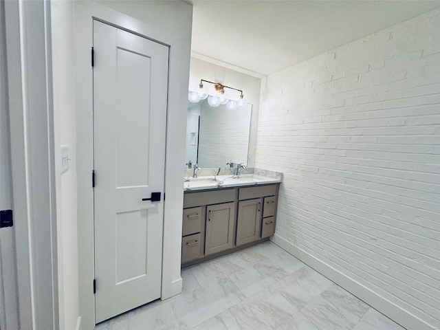 bathroom featuring double vanity, marble finish floor, and a sink