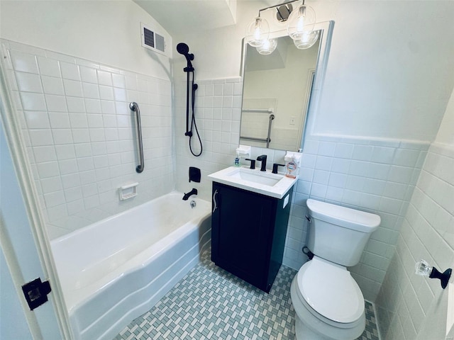 full bath with tile walls, visible vents, toilet, vanity, and tile patterned floors