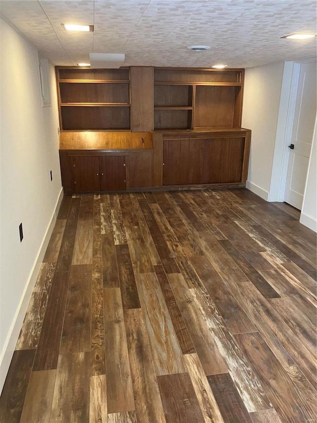 interior space featuring dark wood finished floors and baseboards