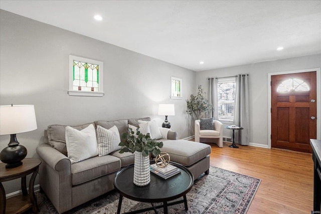 living room with recessed lighting, light wood-type flooring, and baseboards