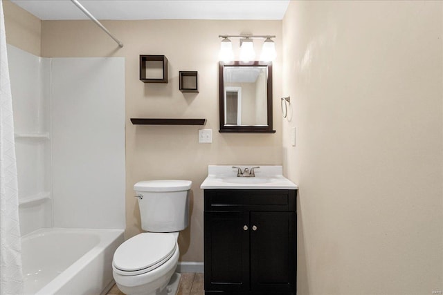 bathroom featuring tub / shower combination, toilet, vanity, and baseboards