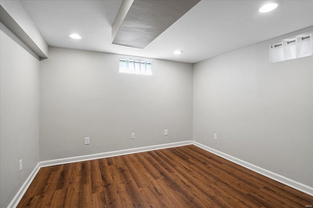 below grade area with recessed lighting, baseboards, and dark wood-style flooring