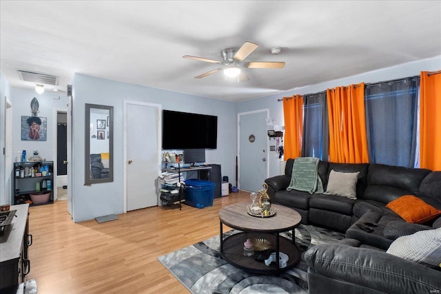 living room featuring wood-type flooring and ceiling fan