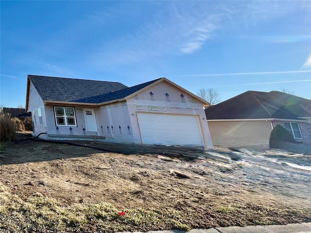 property in mid-construction featuring roof with shingles and an attached garage