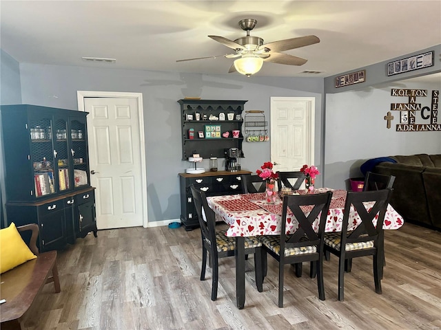 dining area featuring hardwood / wood-style floors and ceiling fan