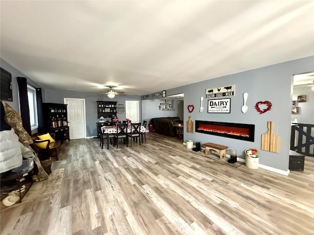 living room with hardwood / wood-style floors and ceiling fan