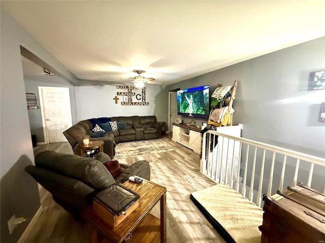 living room with hardwood / wood-style flooring and ceiling fan