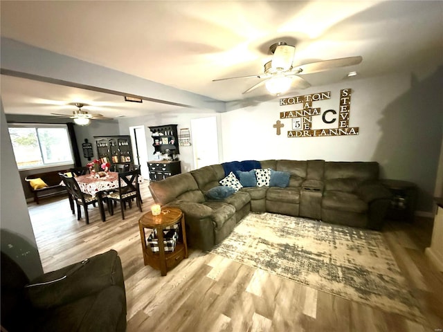 living room featuring ceiling fan and light wood-type flooring