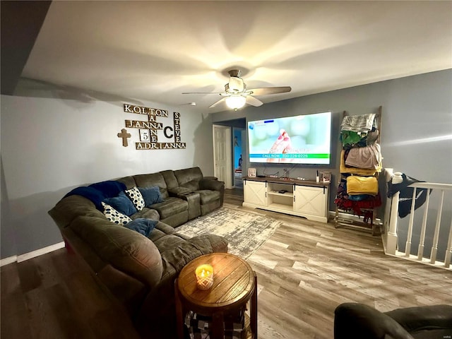 living room with hardwood / wood-style flooring and ceiling fan