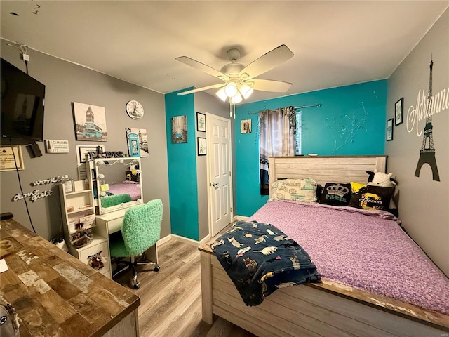 bedroom featuring light hardwood / wood-style floors and ceiling fan