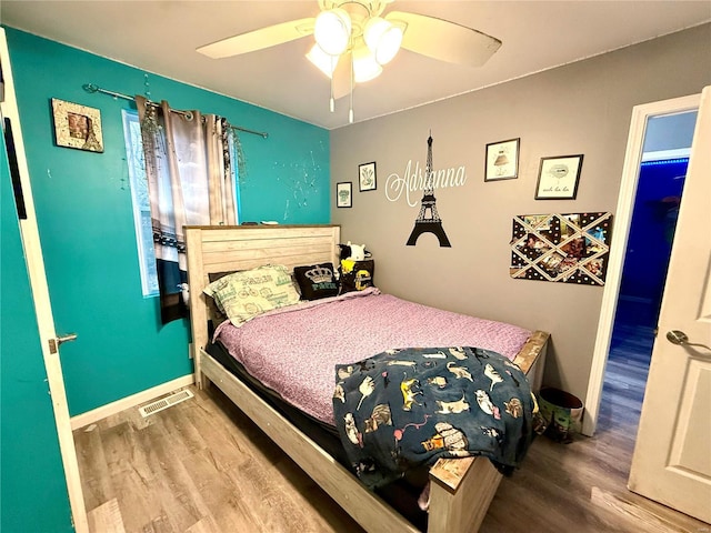 bedroom with wood-type flooring and ceiling fan