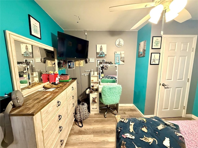 bedroom with ceiling fan and light wood-type flooring