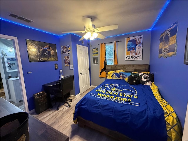 bedroom with ceiling fan and wood-type flooring