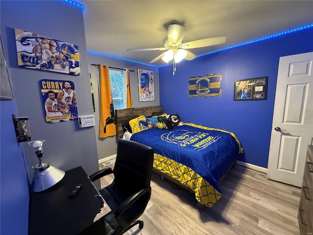 bedroom featuring hardwood / wood-style floors and ceiling fan