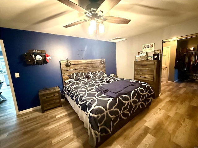 bedroom with hardwood / wood-style flooring and ceiling fan