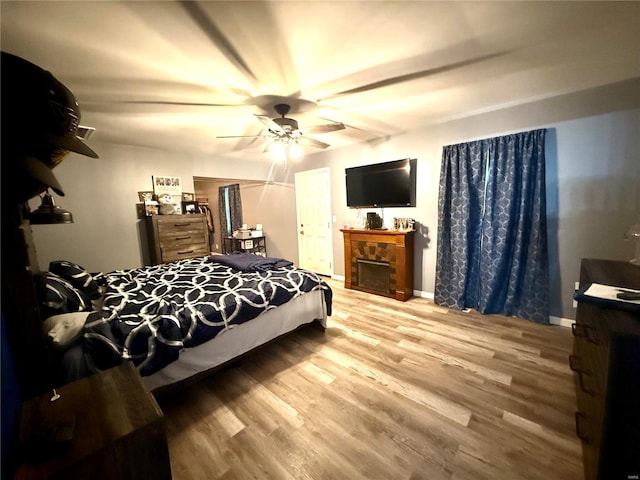 bedroom featuring ceiling fan and wood-type flooring