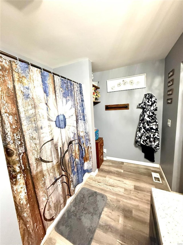 bathroom with hardwood / wood-style floors