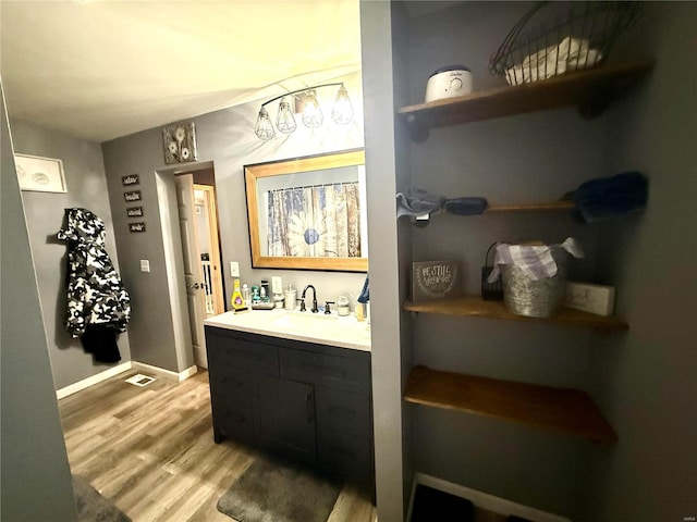 bathroom featuring hardwood / wood-style flooring and vanity