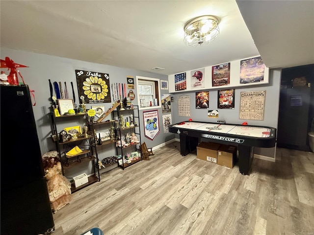 recreation room with light wood-type flooring