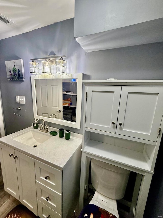 bathroom featuring vanity and toilet