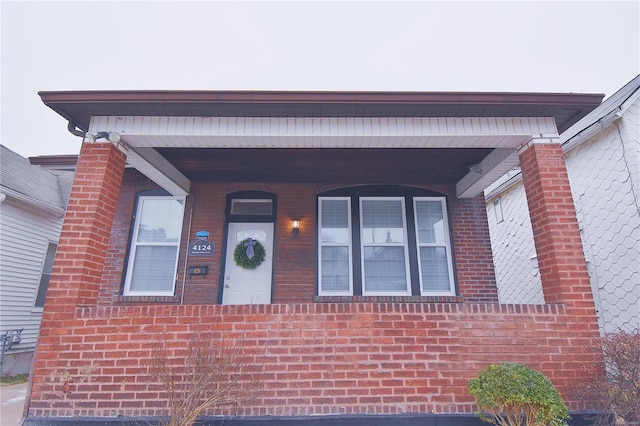 view of front of house with brick siding and a porch