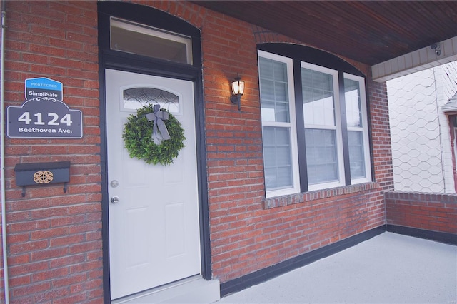 property entrance with brick siding