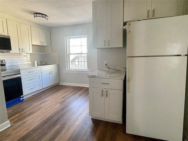 kitchen with white cabinetry, dark wood-type flooring, a textured ceiling, backsplash, and appliances with stainless steel finishes