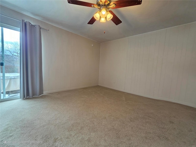 spare room with ceiling fan and carpet floors