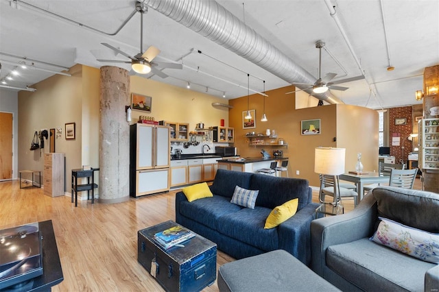 living room with rail lighting, light wood-style flooring, and a ceiling fan