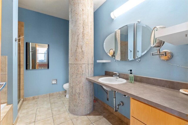 bathroom with tile patterned flooring, a sink, toilet, and a shower stall