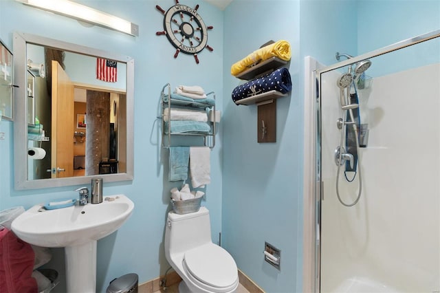 bathroom featuring a shower stall and toilet