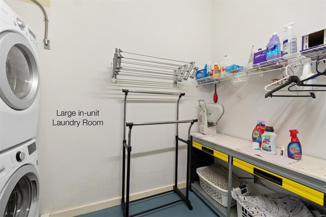 washroom featuring stacked washer and dryer and laundry area