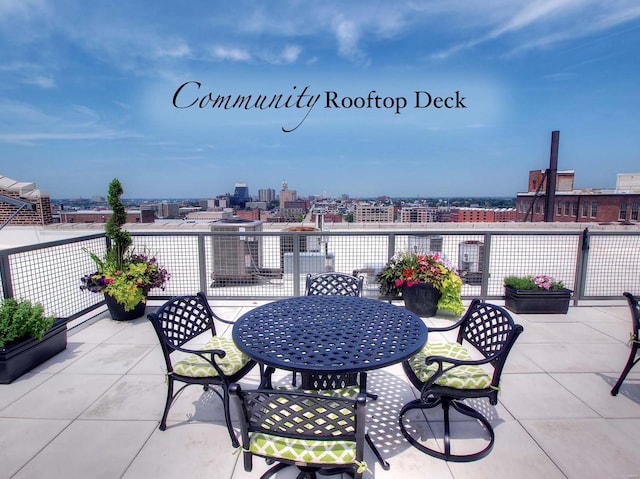 view of patio featuring outdoor dining space and a city view