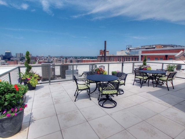 view of patio featuring outdoor dining area and a city view