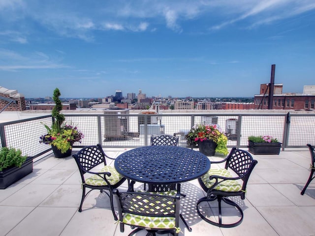 view of patio with a view of city and outdoor dining space